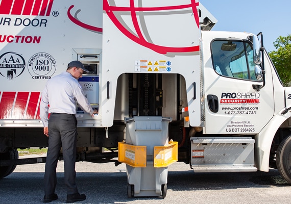 PROSHRED driver linking a secure console bin to our state-of-the-art shredding truck, providing shredding service to the Everette community