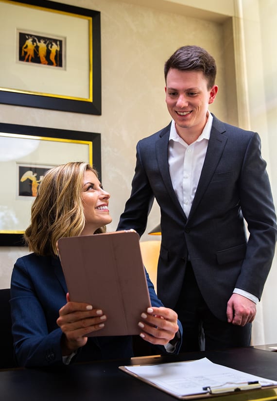 Male and female business professionals discussing a document.