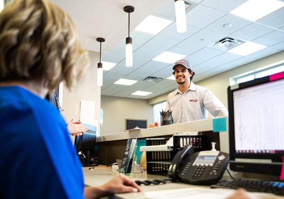 Man picking up materials for shredding from an office receptionist.