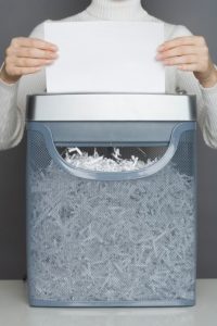 Woman using a paper shredder