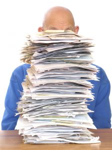 a man looking a a stack of papers