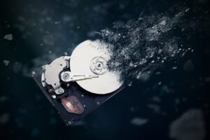 The old hard disk drive is disintegrating in space. Conception of passage of time and obsolete technology