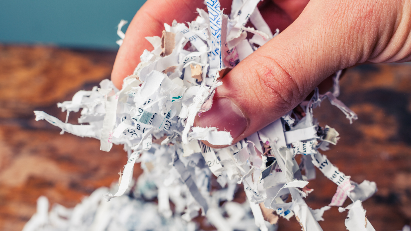 someone grabbing shredded paper