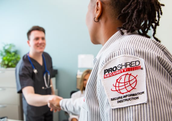 PROSHRED employee shaking hands with a medical professional.