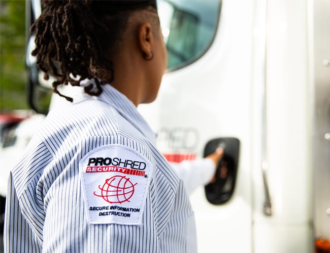 PROSHRED employee opening the door on a mobile shredding truck.