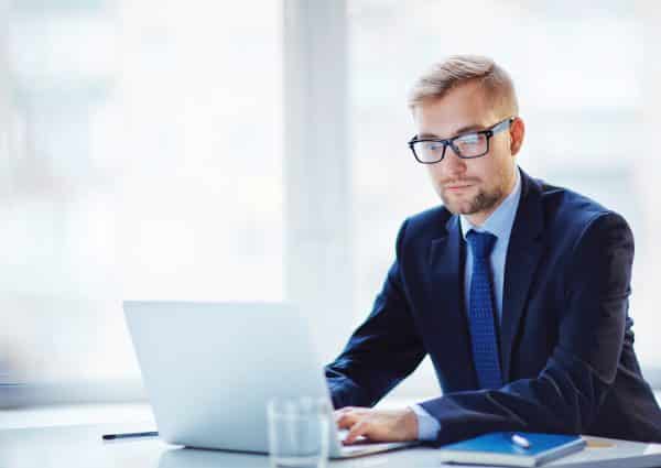 Businessman searching for information on a computer.