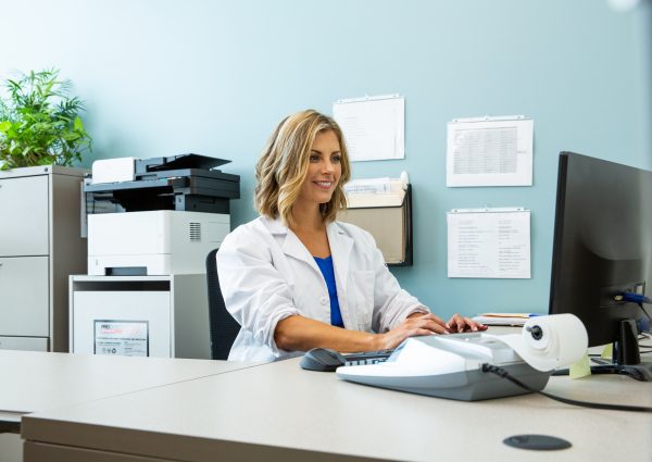 Medical professional looking at information on a computer.