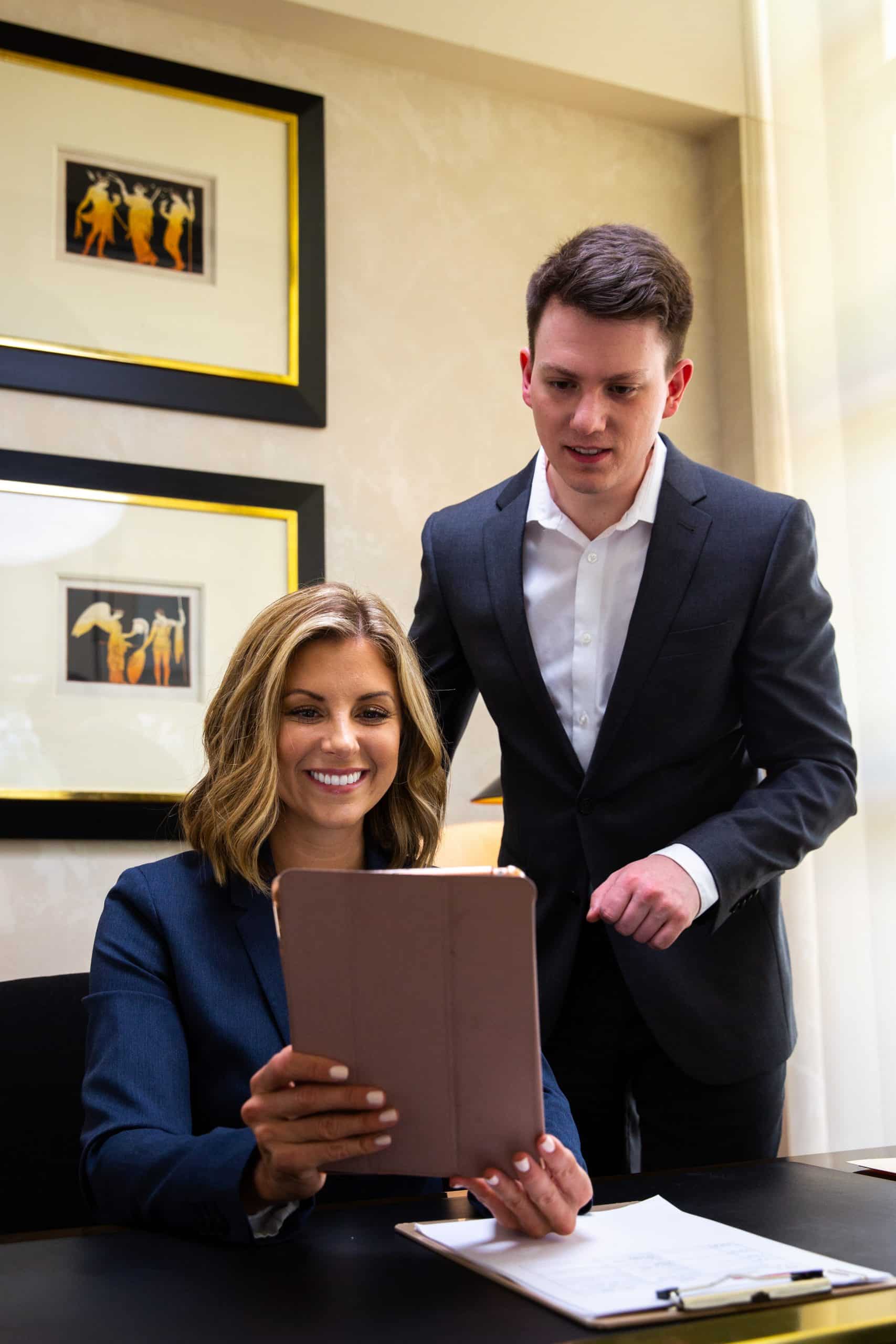 Two business professionals reviewing a document.