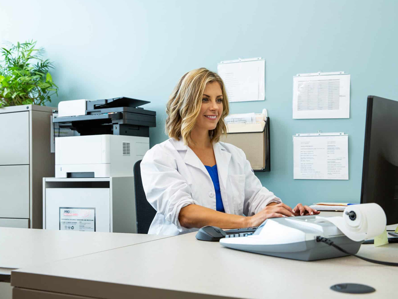 Medical professional looking at information on a computer.