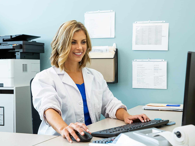 Healthcare worker accessing information digitally.