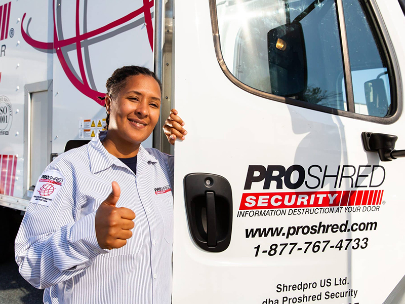 PROSHRED® Security Driver Giving a Thumbs Up Outside a Mobile Shredding Truck