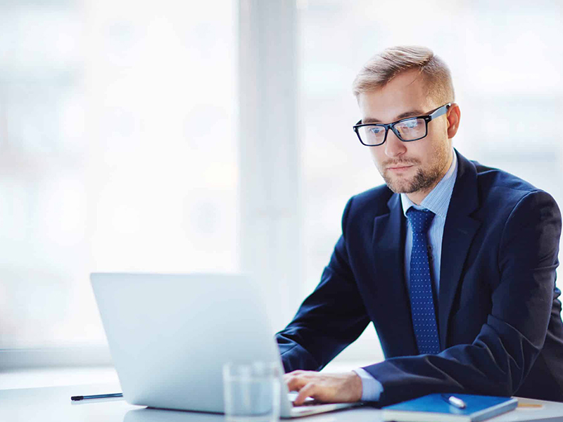 Businessperson searching for information on a computer.