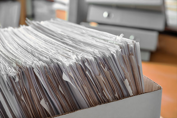 Box with paper documents ready for scanning.