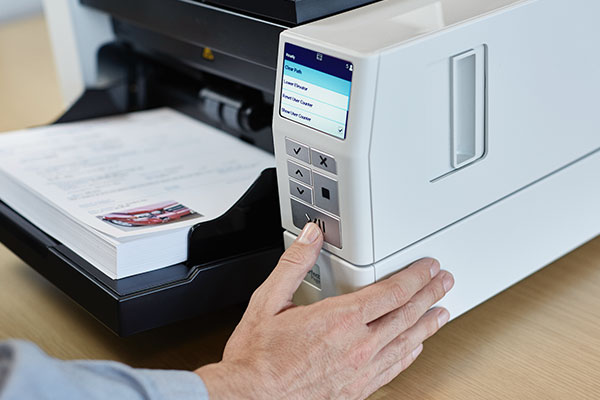 Man scanning a paper document.