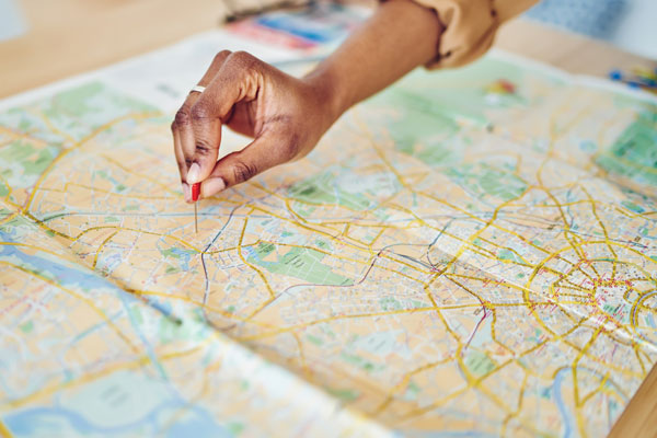 Woman indicating a location on a physical map