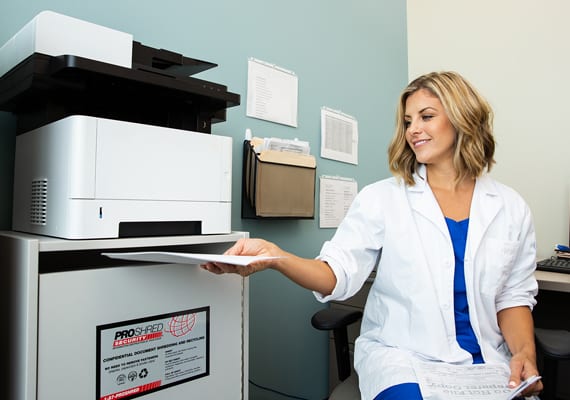 Medical professional shredding documents