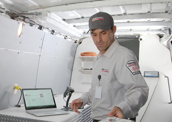 Inside a PROSHRED shredding truck with an employee inside destroying hard drives