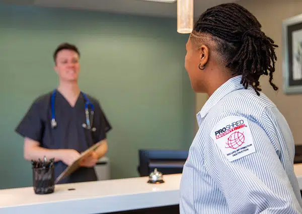 local shredding - PROSHRED employee talking with a healthcare professional