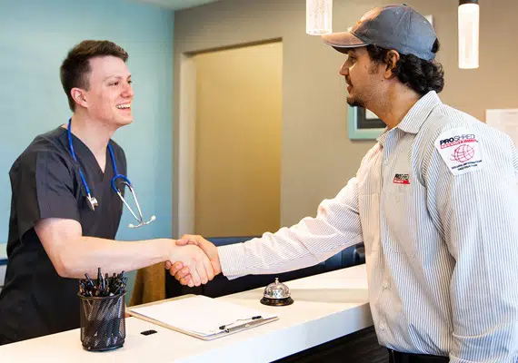 PROSHRED security bonded employee shaking hands with a healthcare professional