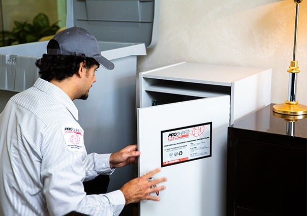 PROSHRED employee removing the bag inside the secure console bins to shred its contents