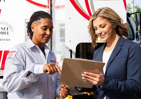 PROSHRED employee reviewing documents with a client 
