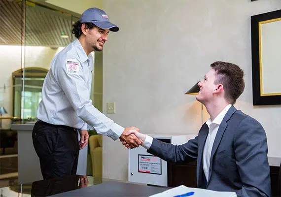 PROSHRED employee shaking hands with a business client, Choose Secure Document Shredding