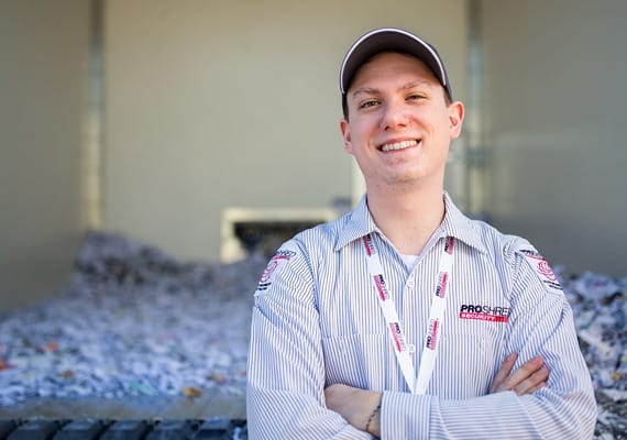 PROSHRED driver behind our shredding truck after completing a shredding job