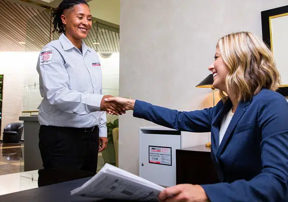 Proshred employee with a client shaking hands