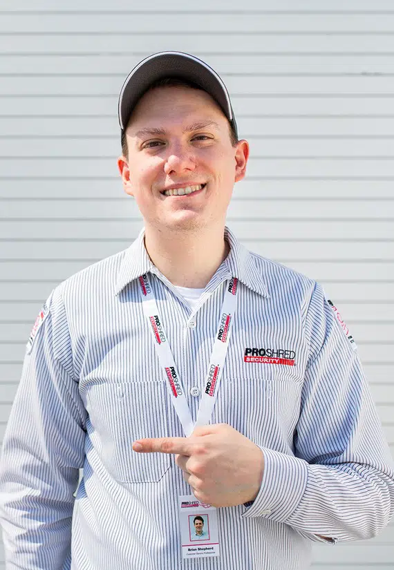 PROSHRED employee wearing his uniform posing for the camera
