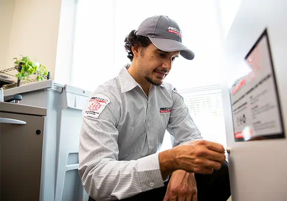 PROSHRED employee opening up a secure console bin inside an office