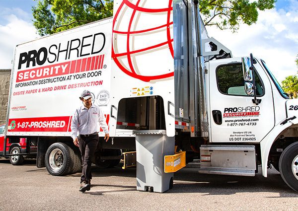 Shredding process - PROSHRED driver shredding confidential information with our mobile shredding trucks
