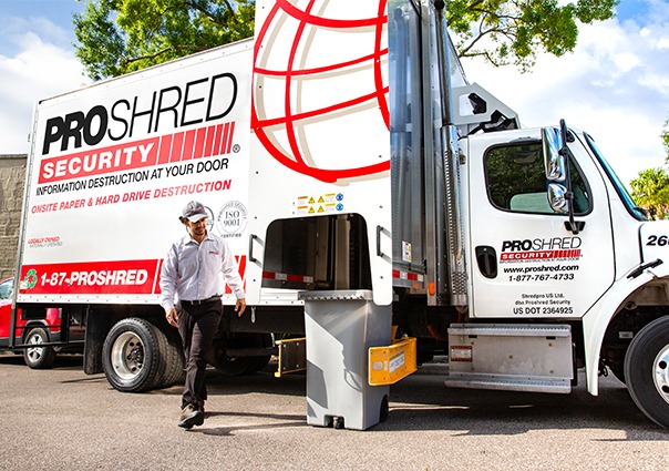 PROSHRED employee shredding documents that will be recycled after, in our onsite shredding tucks, 
