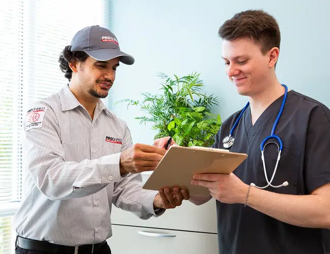 PROSHRED employee reviewing paperwork with a healthcare professional