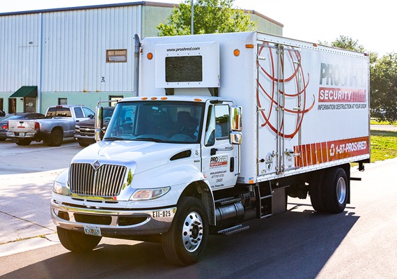 mobile shredding truck infront of a warehouse 