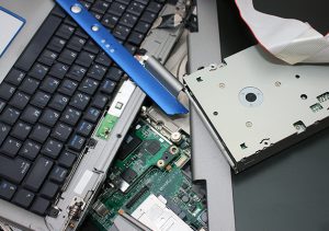 Computer hard drive and other components, securely being destroyed.
