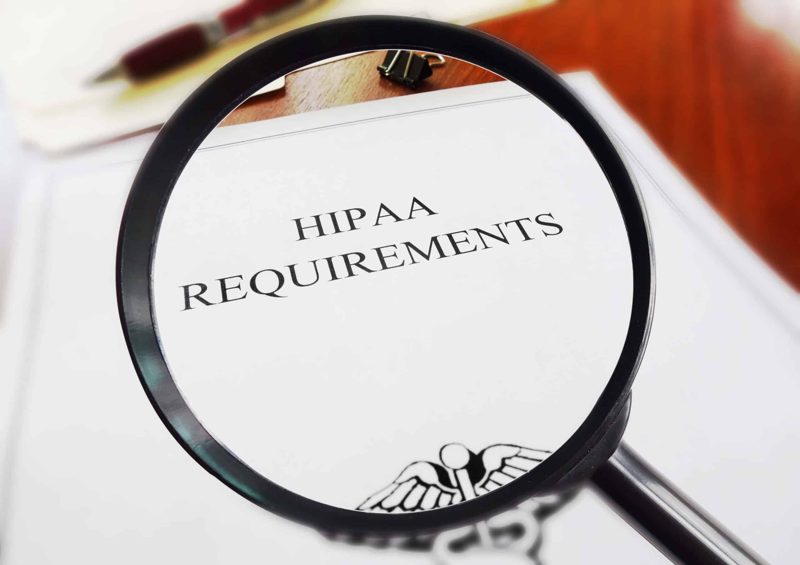 HIPAA requirements on a document under a magnifying glass.
