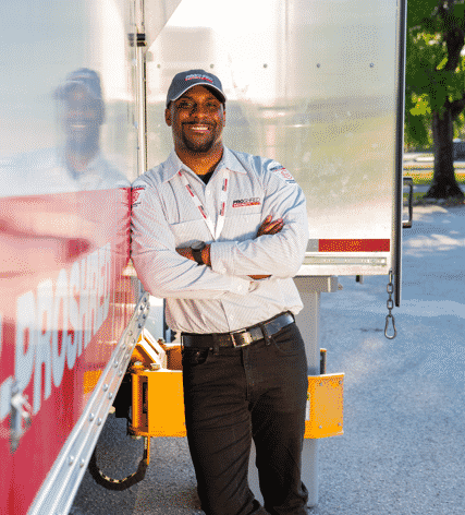 certified hard drive degaussing employee beside a PROSHRED shredding truck