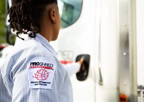 PROSHRED employee getting into a PROSHRED onsite shredding truck