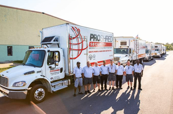 PROSHRED drivers lined up in front of PROSHRED mobile shredding trucks