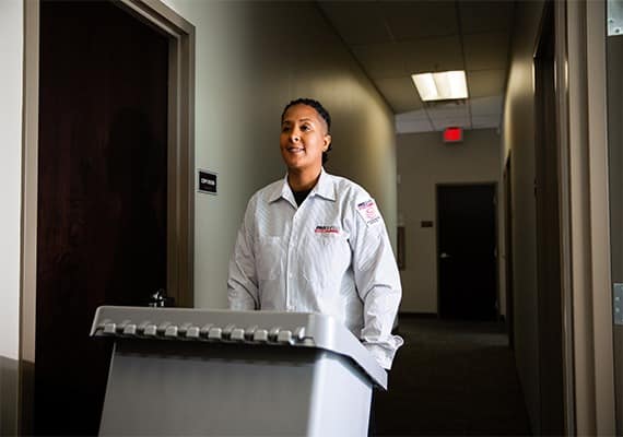 PROSHRED employee collecting a secure console bin at an office