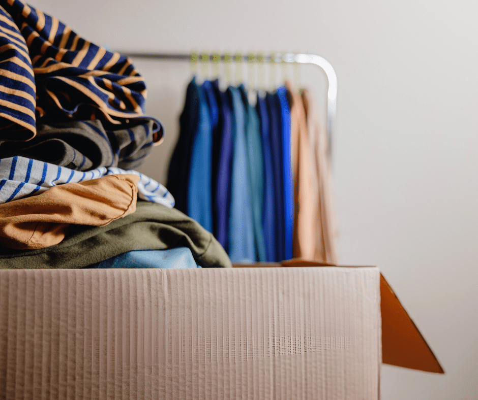 A box and rack of old branded clothes